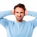 irritated man blocking his ears by stockimages